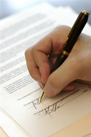 closeup of a hand signing a contract